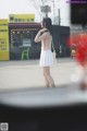 A woman standing in front of a coffee shop.